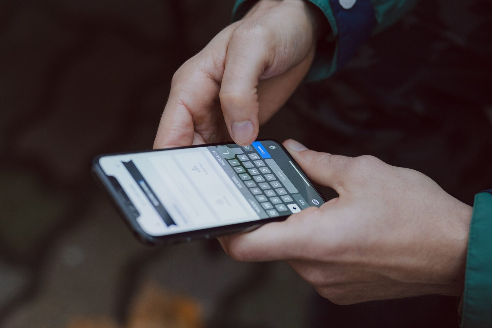 Close-up of person texting on a smartphone. Outdoor setting with wireless connectivity.